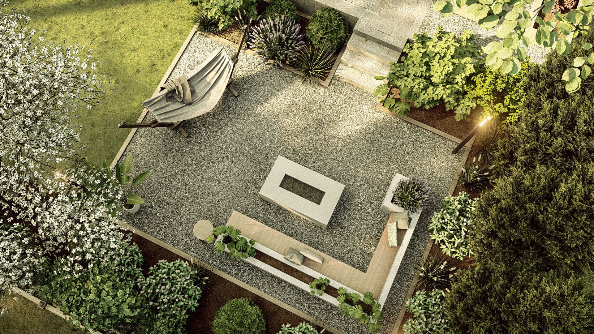 Overhead view of a tranquil garden retreat with gravel ground, modern fire pit, outdoor seating, and surrounded by lush greenery and flowering plants.